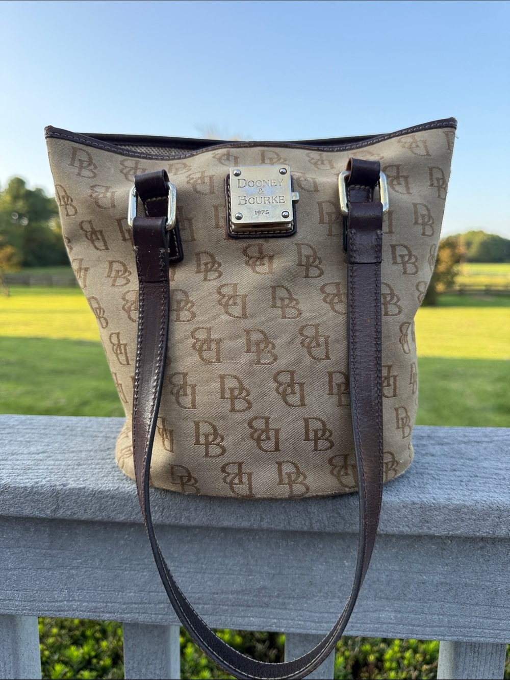 Dooney & Bourke Tan Logo Bucket Bag with Brown Leather Trim